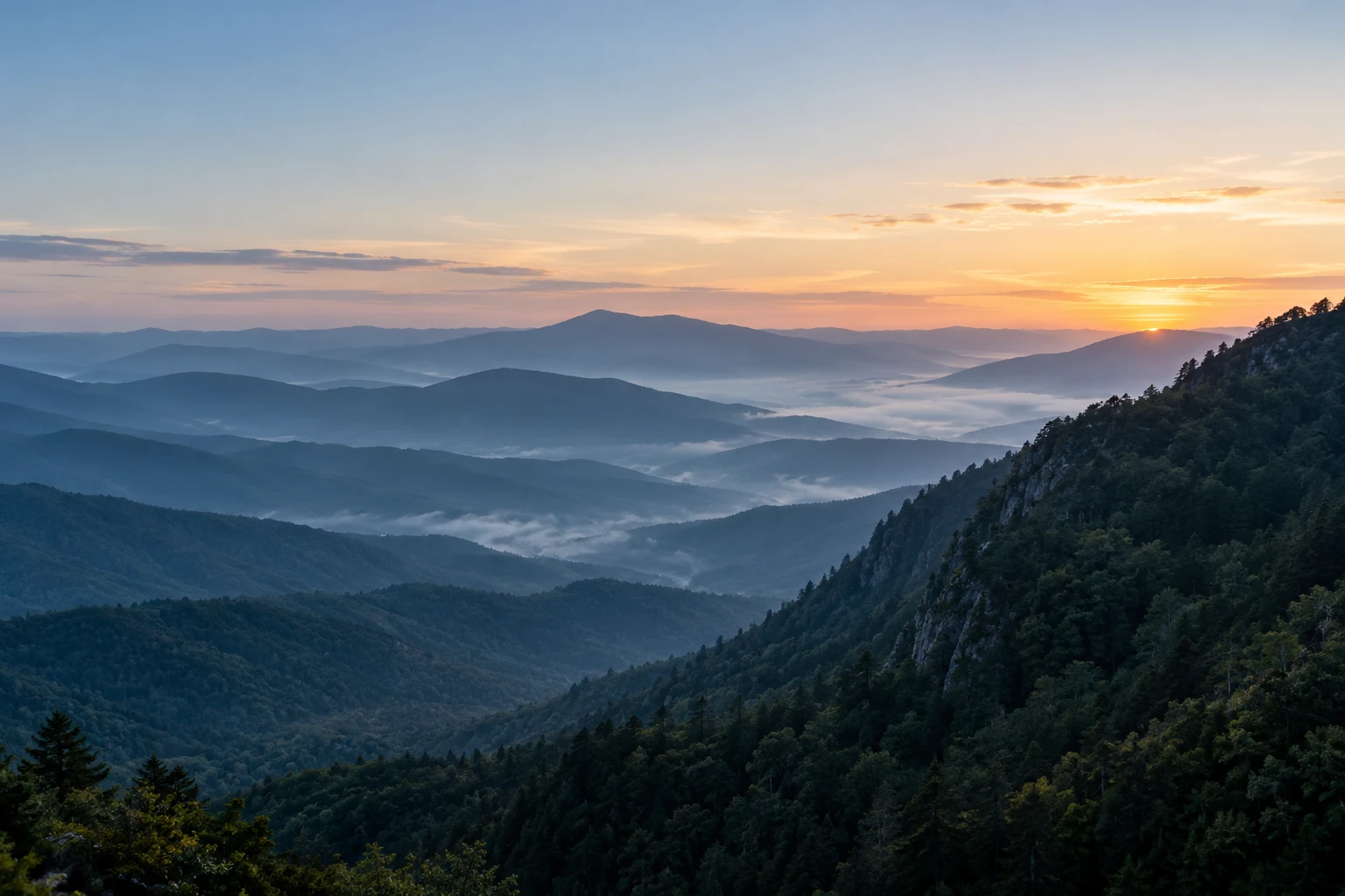Layered mountain ridges opening to a new horizon at dawn